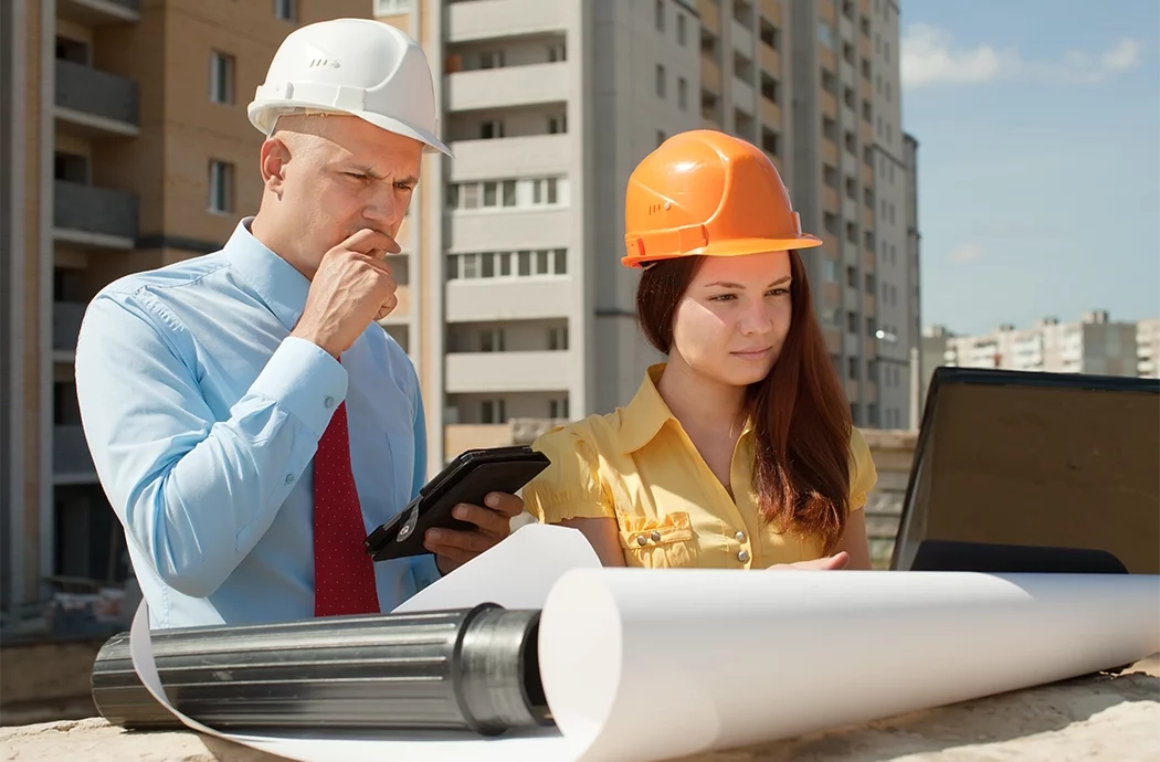 Deux chefs de chantier concentrs sur leur ordinateur sur un chantier